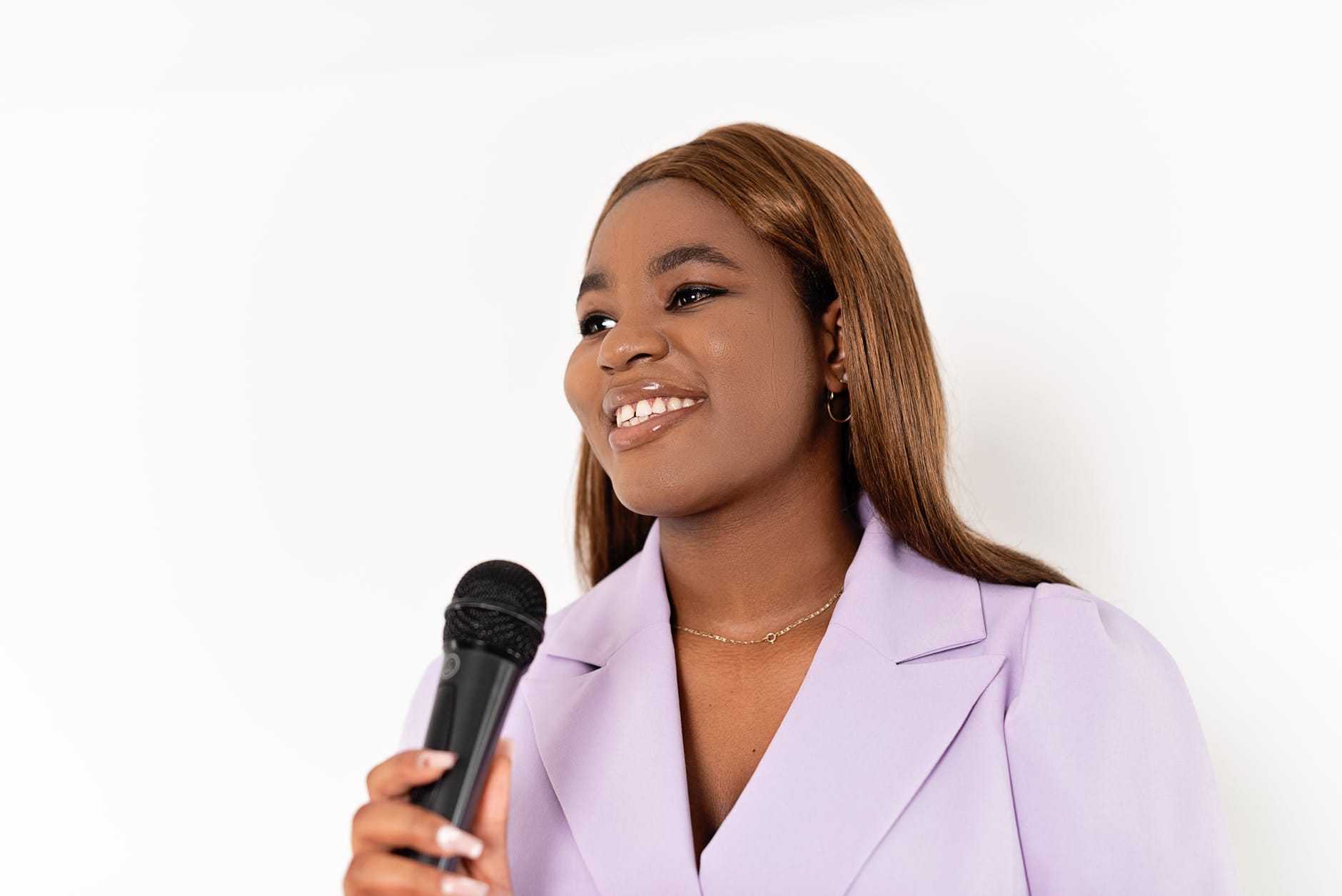 a smiling woman holding a microphone